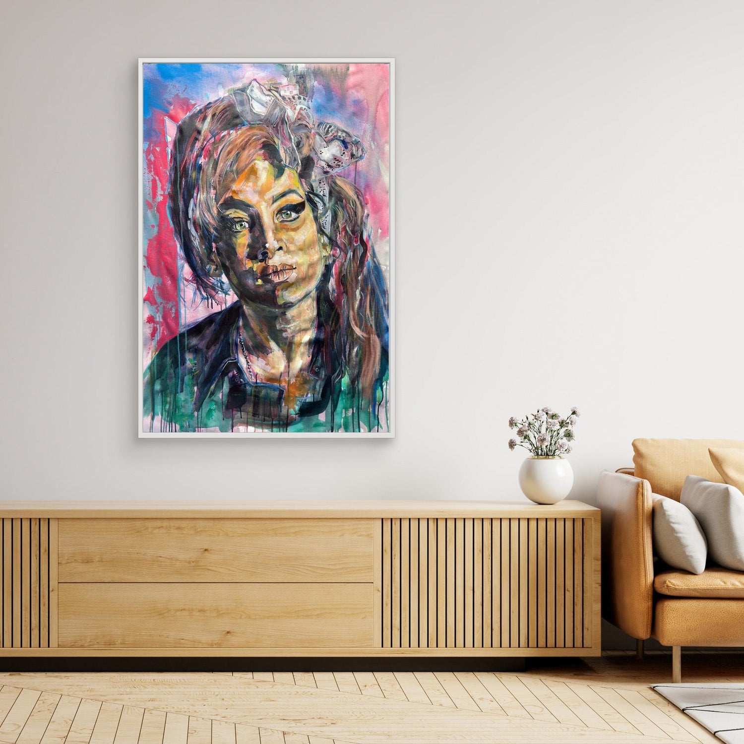 Amy Winehouse original painting portrait on a wall above a wooden console table in a living room.