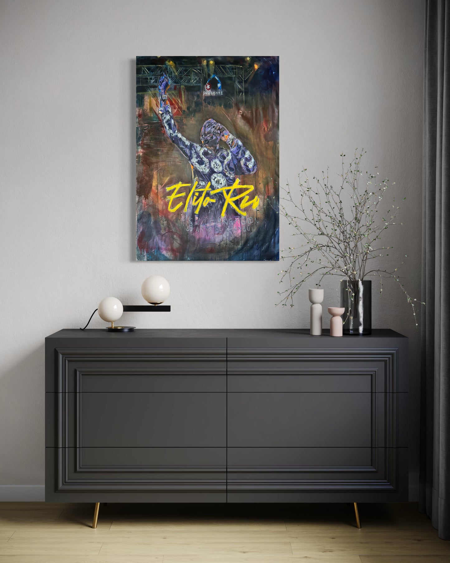 Elito Reve portrait painting displayed above gray dresser