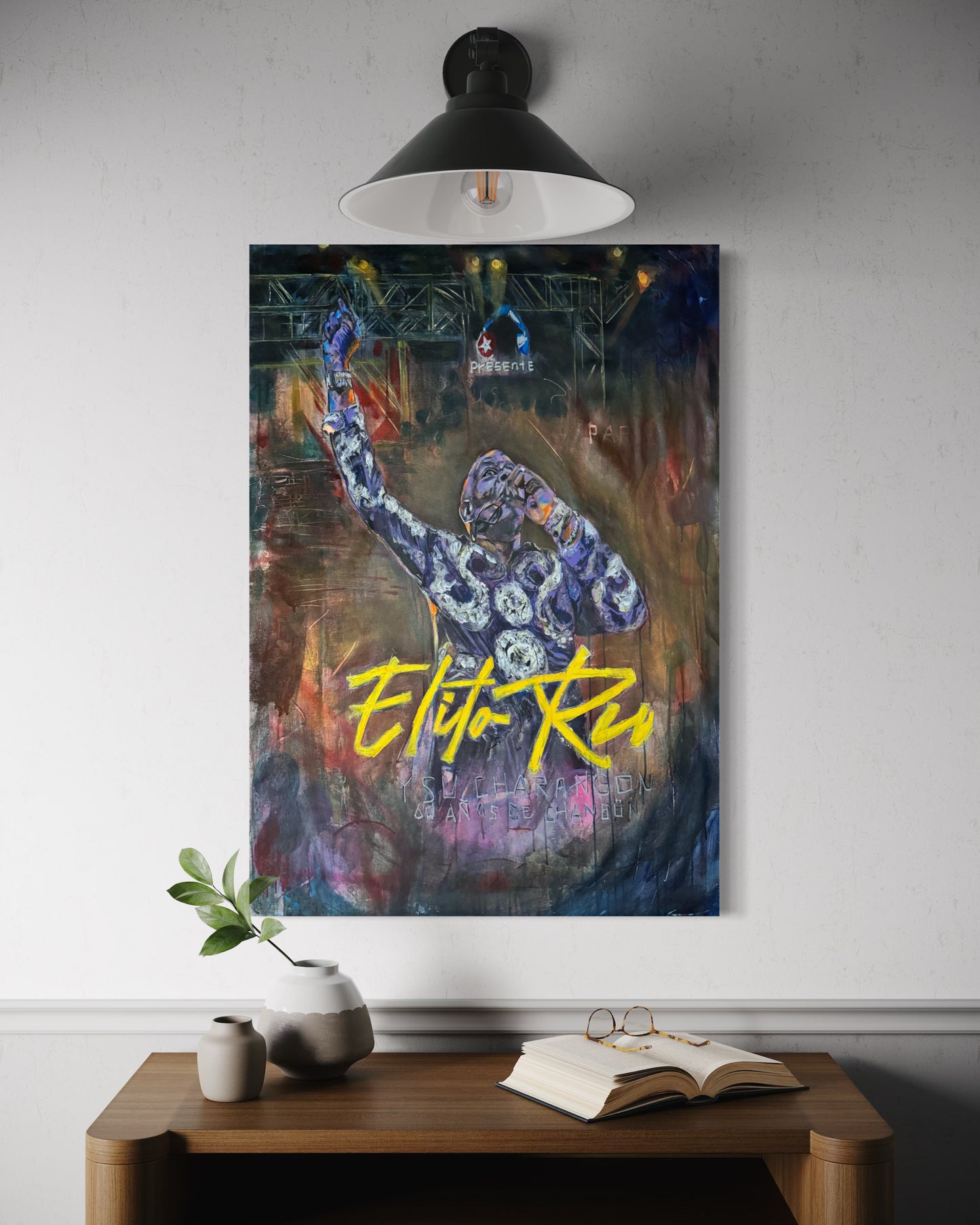 Elito Reve portrait painting above dresser with book