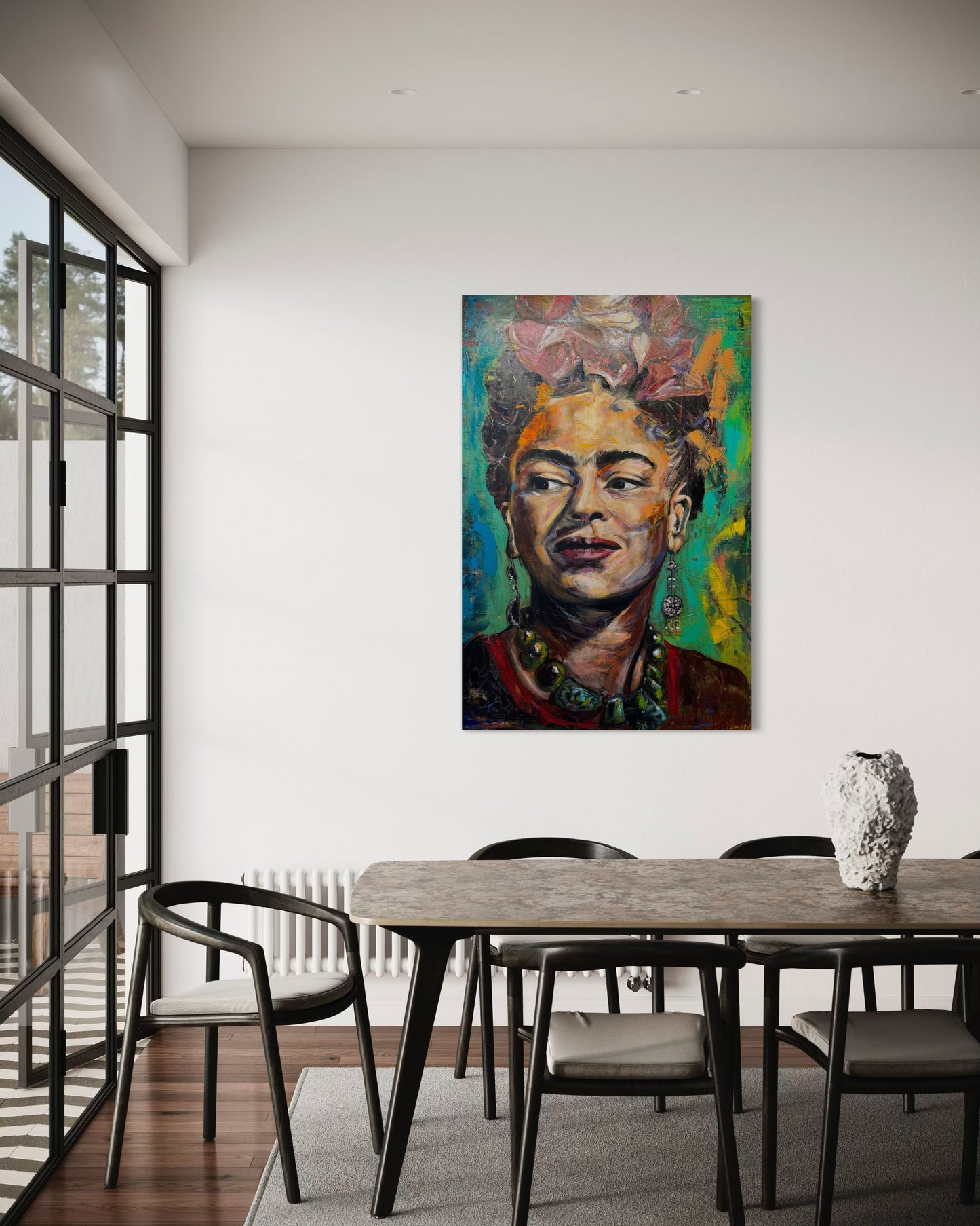 Frida Kahlo painting above dining table next balcony door