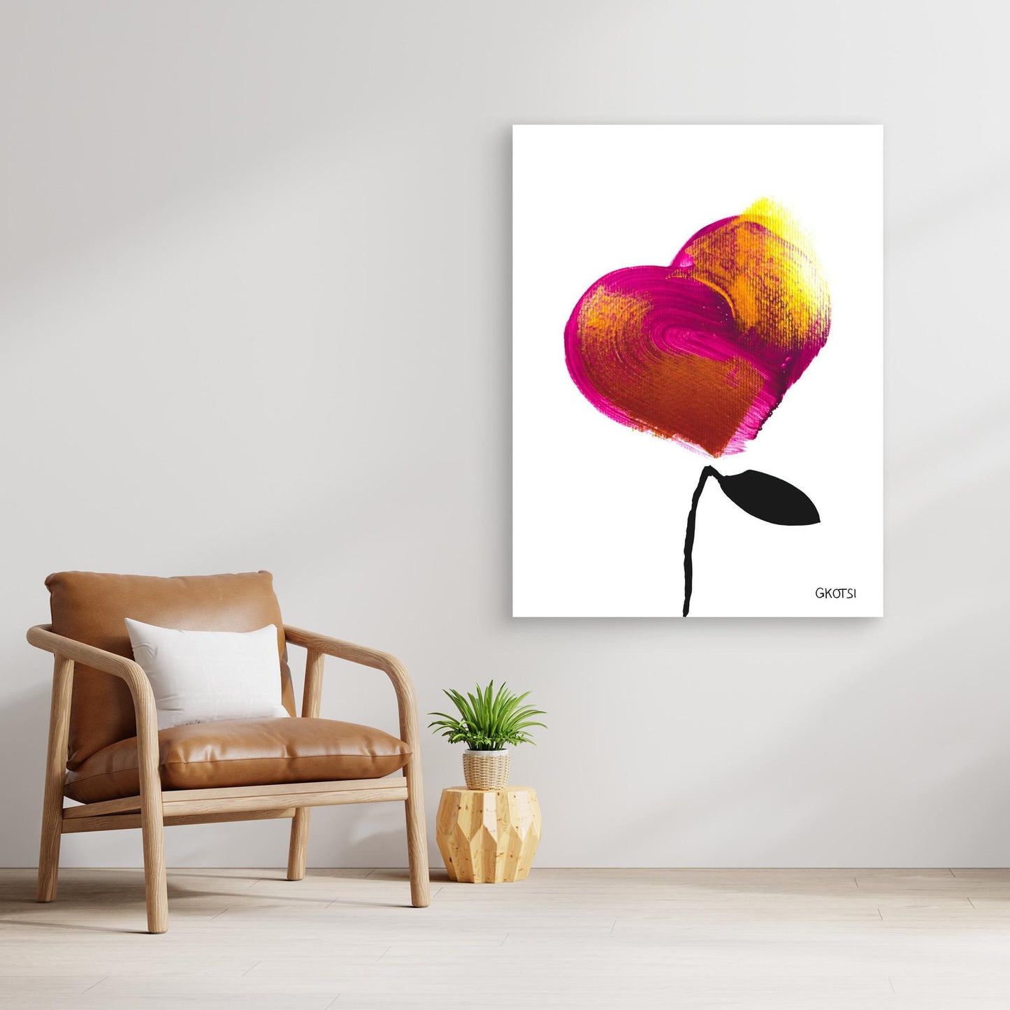 LOVE canvas print above wooden chair with small plant