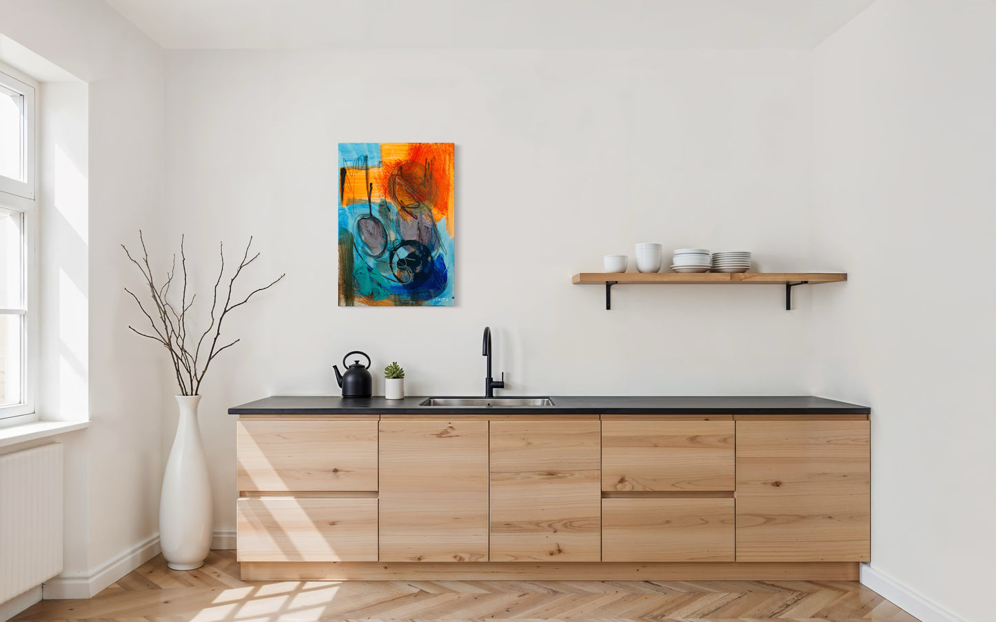 Modern kitchen with wooden cabinets, black countertop, and colorful abstract painting on wall.