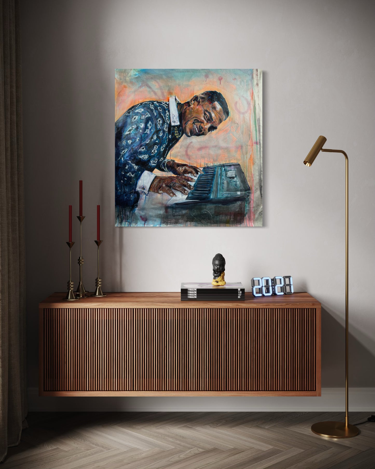 Manolito y su Trabuco above a wooden dresser with candles and floorlamp