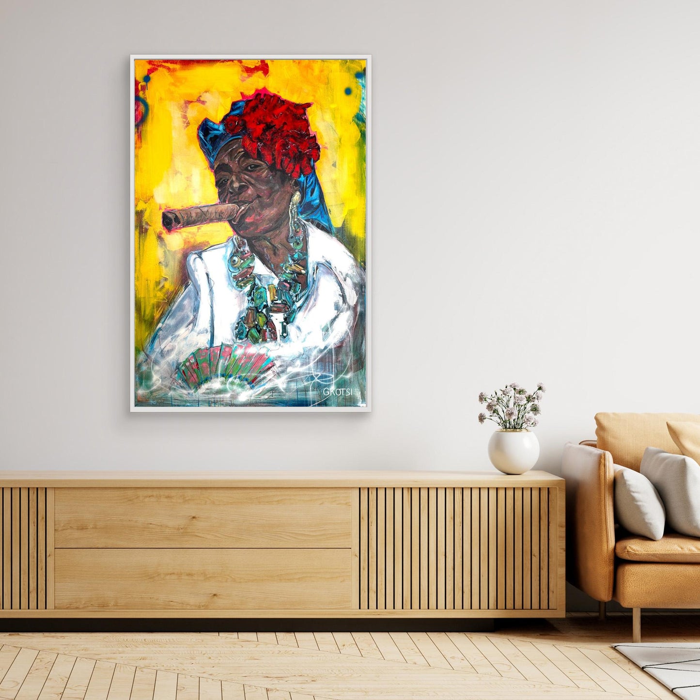 CUBAN WOMAN WITH CIGAR Canvas Print by Elena Gkotsi displayed above wooden sideboard with decorative plant and modern chair in minimalist interior