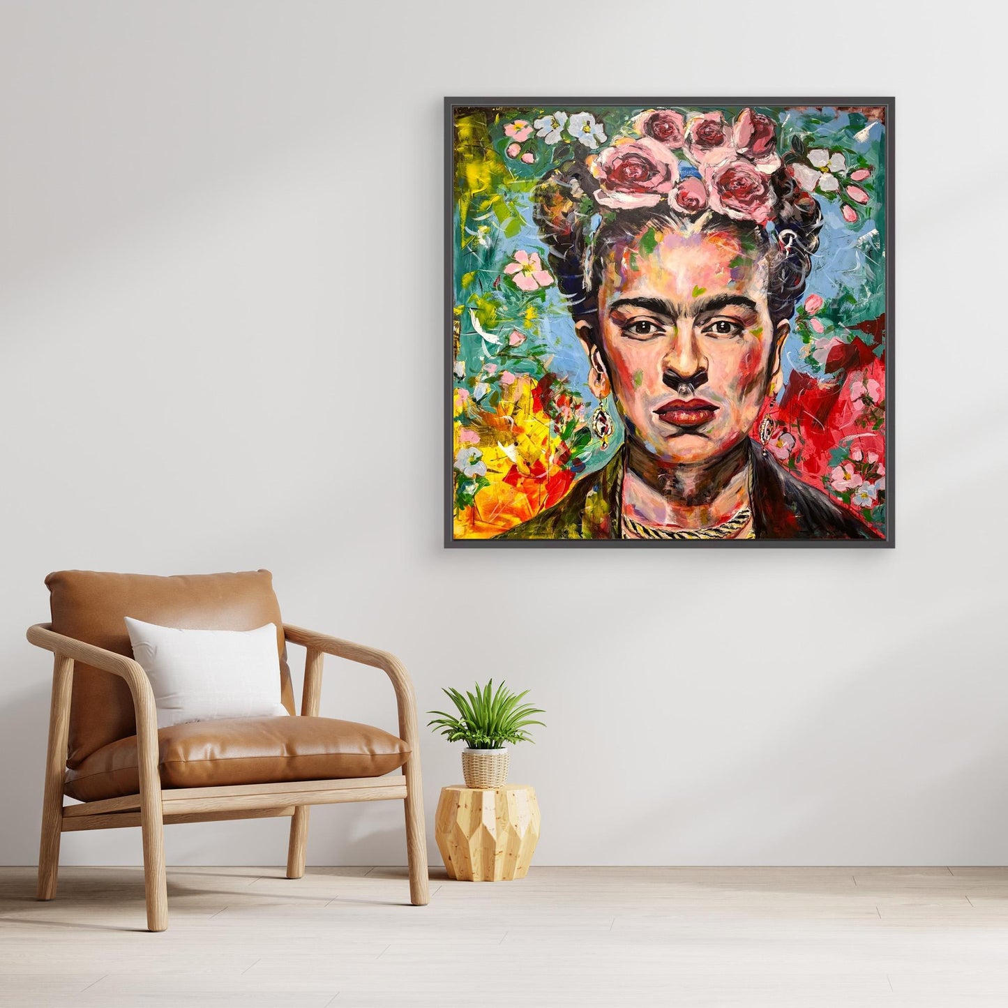 FRIDA KAHLO 1 Canvas Print hanging over small plant and contemporary chair in scandinavian style room