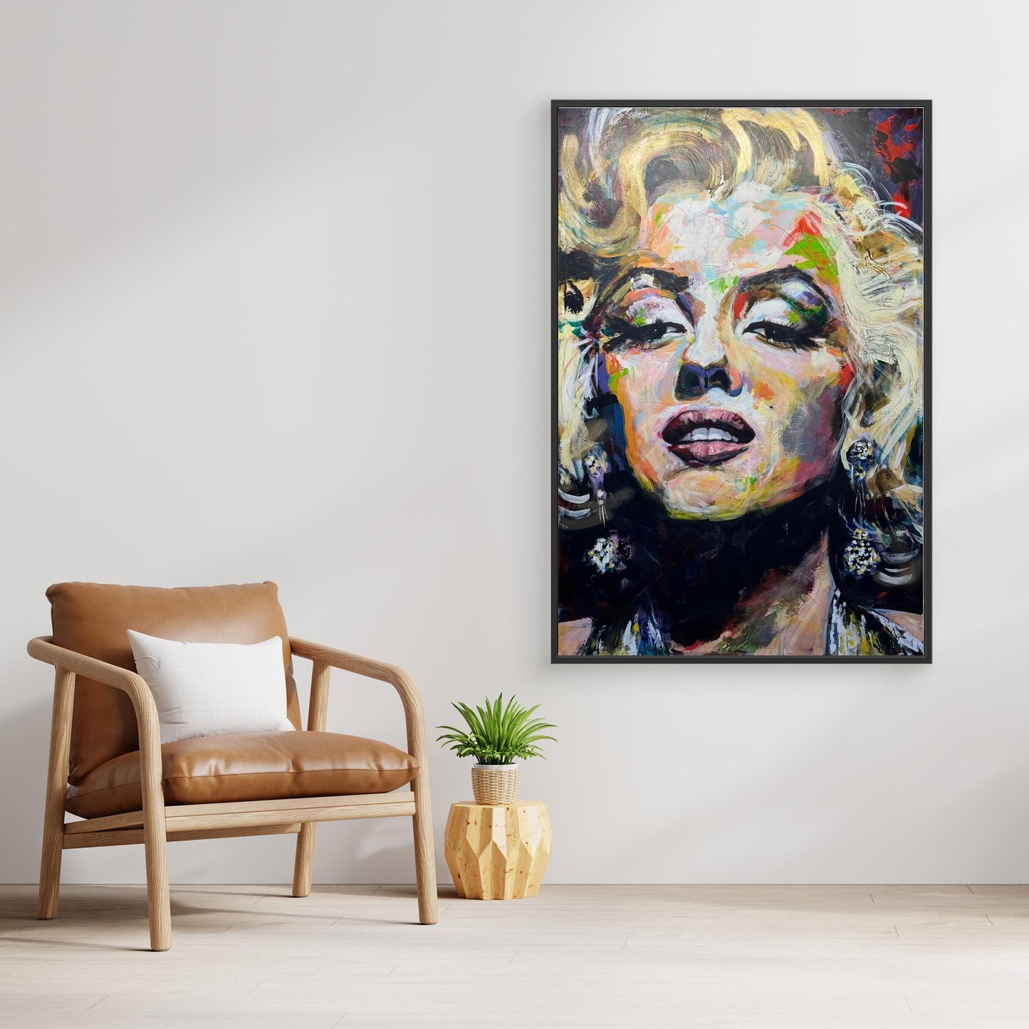 MARILYN MONROE 1 canvas print with black frame displayed above stylish chair