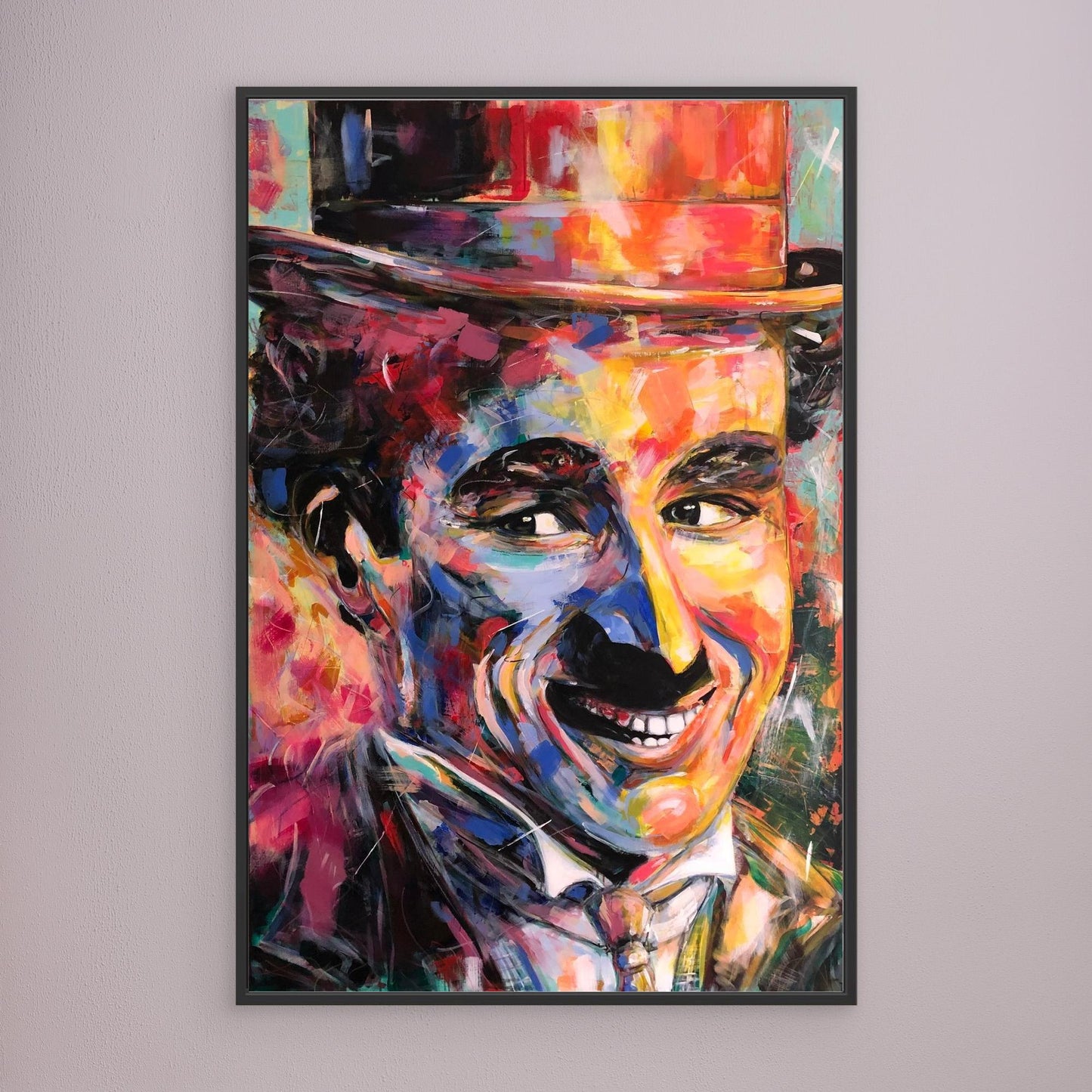 CHARLIE CHAPLIN canvas print with black frame displayed on gray wall