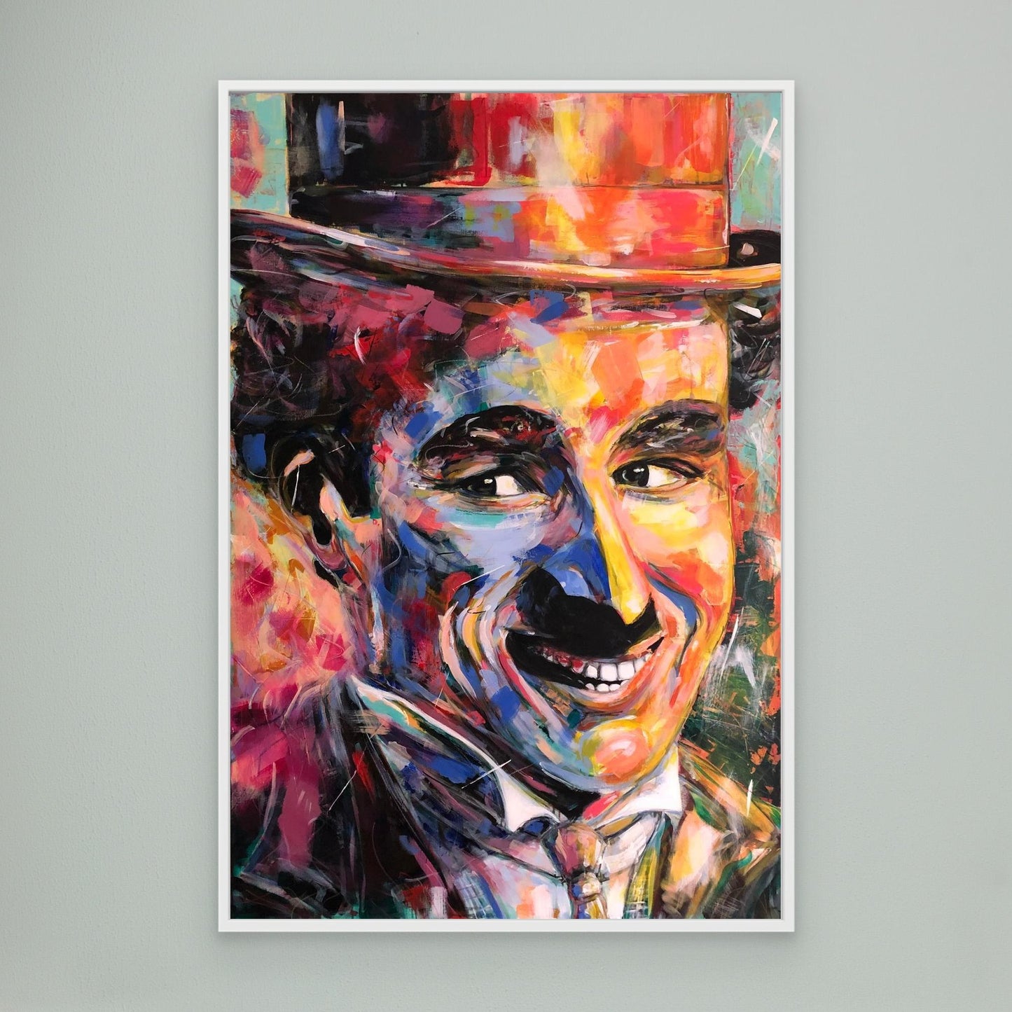 CHARLIE CHAPLIN canvas print with white frame displayed on gray wall