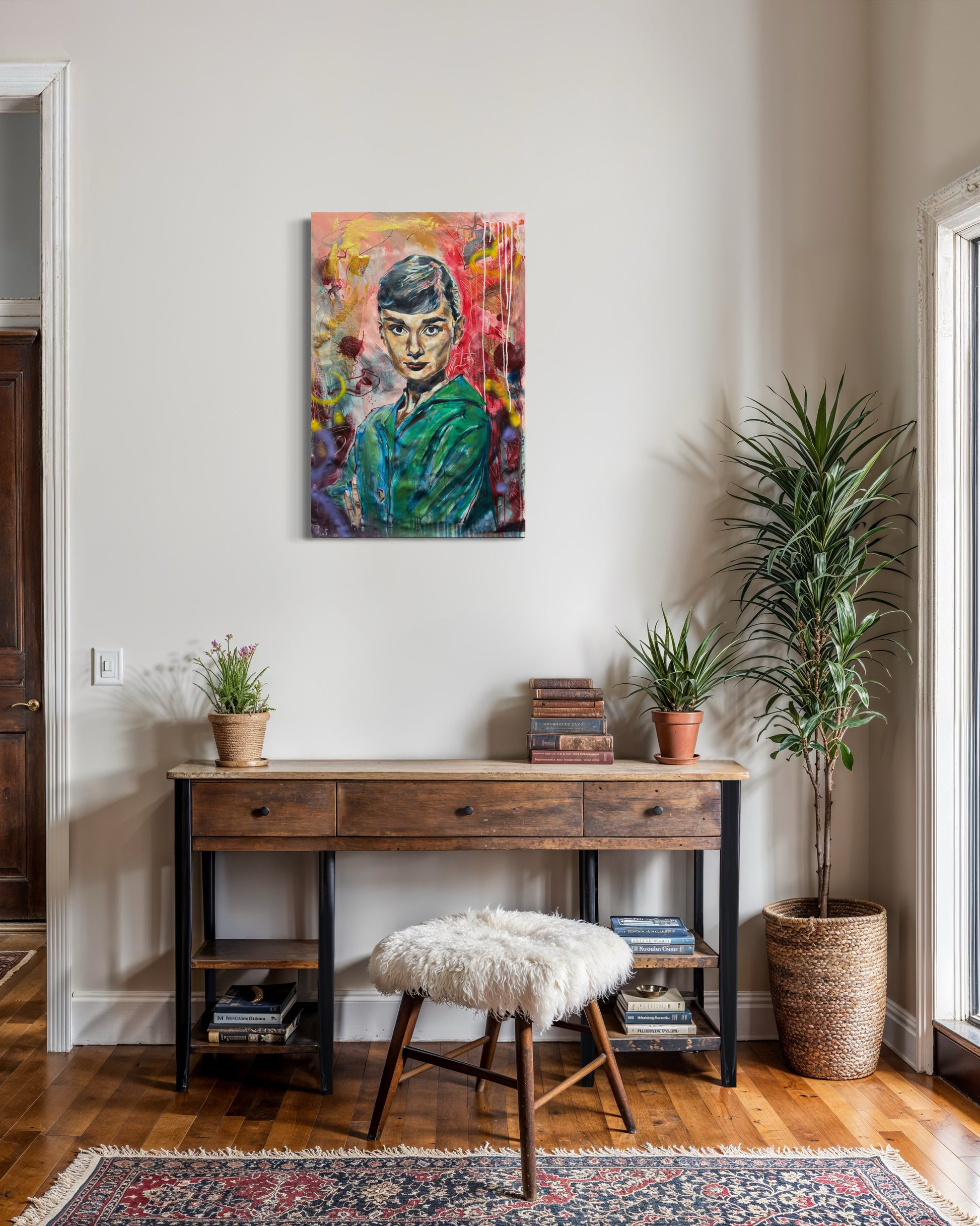 Audrey Hepburn artwork above old wooden desk